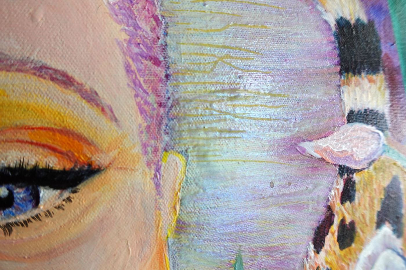 Close-up of Loved Wildly: painted eye and lashes beside the iridescent halo and a striped tail